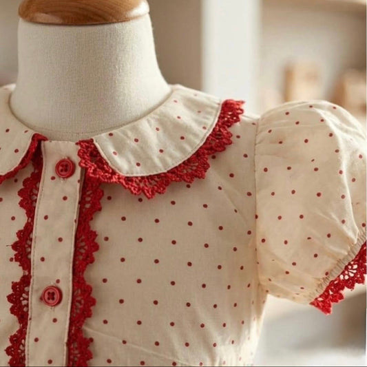 Peter Pan collar and puff sleeve detail on ivory polka dot girls dress