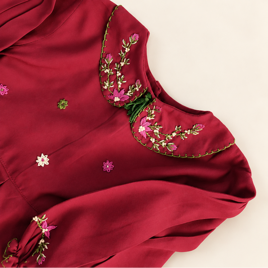 Floral hand embroidery on the deep red dress collar