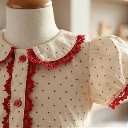 Peter Pan collar and puff sleeve detail on ivory polka dot girls dress