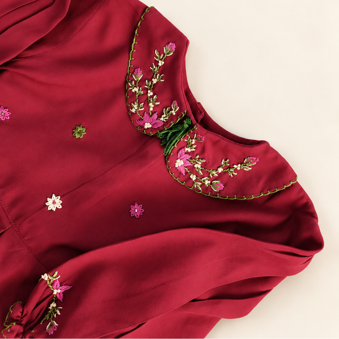 Floral hand embroidery on the deep red dress collar