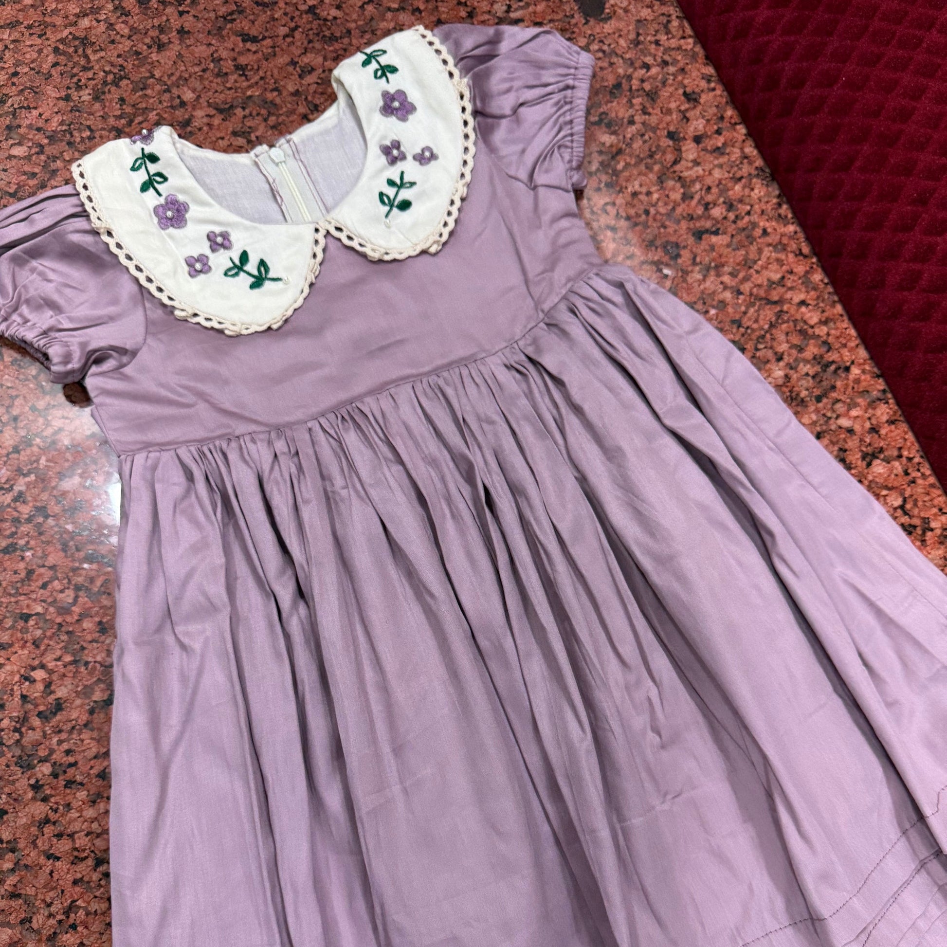 Front view of lavender dress showing gathered skirt and embroidered collar