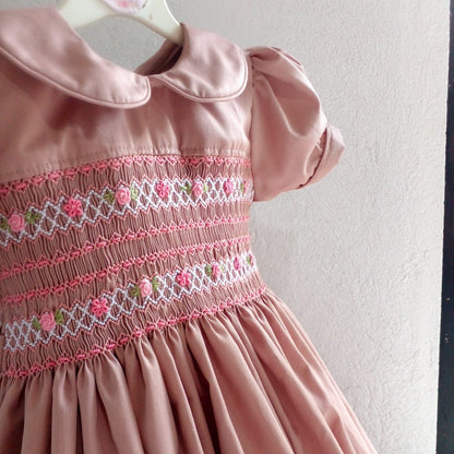 Side close-up showing smocking detail, puffed sleeve and Peter Pan collar of dusty rose dress